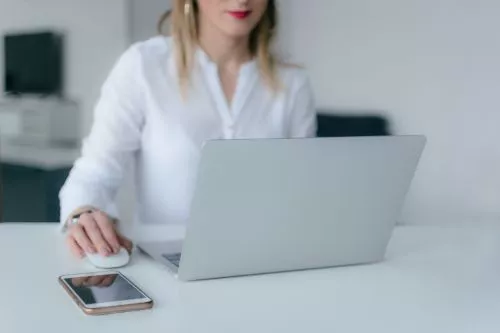 A photo of a woman sitting at a computer